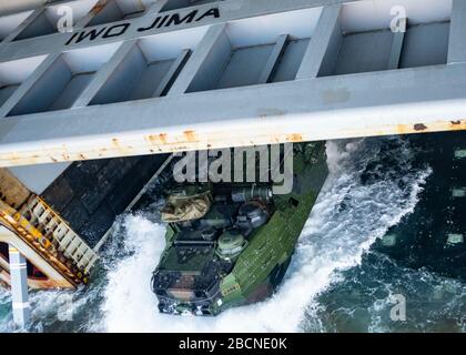 ONSLOW BAY, N.C. (March 18, 2020) – An Amphibious Assault Vehicle (AAV) assigned to 2nd Assault Amphibian Battalion (2nd AABN), 2nd Marine Division based out of Camp Lejeune, N.C. launches off the well deck onboard the Wasp-class amphibious assault ship USS Iwo Jima (LHD 7), March 18, 2020. Iwo Jima and the 2nd AABN are conducting amphibious assault operations certification in the Atlantic Ocean. (U.S. Navy photo by Mass Communications Specialist 3rd Class Jessica Kibena/Released) Stock Photo