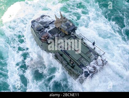 ONSLOW BAY, N.C. (March 18, 2020) – An Amphibious Assault Vehicle (AAV) assigned to 2nd Assault Amphibian Battalion (2nd AABN), 2nd Marine Division based out of Camp Lejeune, N.C. launches off the well deck onboard the Wasp-class amphibious assault ship USS Iwo Jima (LHD 7), March 18, 2020. Iwo Jima and the 2nd AABN are conducting amphibious assault operations certification in the Atlantic Ocean. (U.S. Navy photo by Mass Communications Specialist 3rd Class Jessica Kibena/Released) Stock Photo