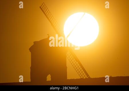 The sun rises over Chesterton Windmill in Warwickshire. Stock Photo