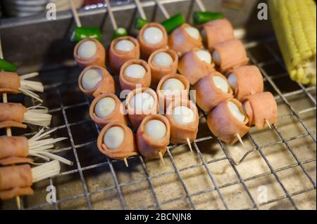 Set of delicious skewers on night food market in Thailand. Stock Photo