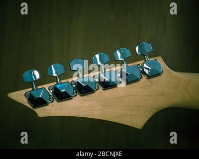 Guitar head with silver tuning pegs or keys. Close up with tuners or machine heads of a guitar. Stock Photo