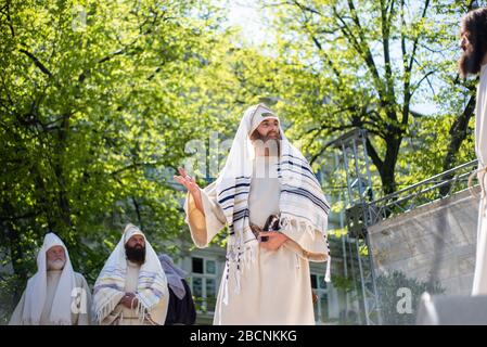 Easter theatrical reconstruction. Awesome acting game. Betrayal, death and resurrection of Jesus Christ. Jews, Roman soldiers, disciples of Jesus and Stock Photo