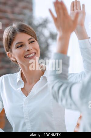 members of the business team giving each other a high five. Stock Photo