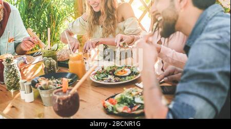 Hands view of young people eating brunch and drinking smoothies bowl with ecological straws in trendy bar restaurant - Healthy lifestyle, food trends Stock Photo