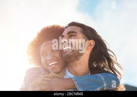 Multiracial couple having tender moments outdoor - Caucasian man and african woman having fun together during vacation - Travel, love and multi thnic