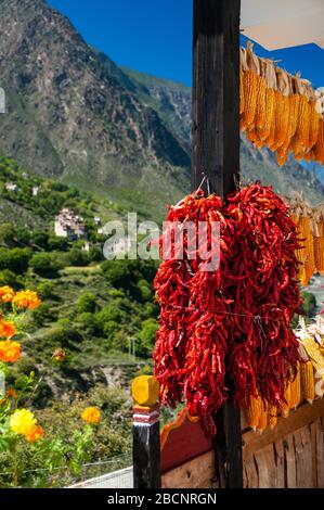 Chilies and corn drying on a roof in the Tibetan village of Suopo in the former Kham kingdom now part of Danba, Sichuan Province, China. Stock Photo