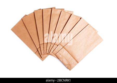 Group of simple blank brown small paper bags set spread out. Lots of tiny new flat biodegradable, recyclable eco friendly empty grocery retail Stock Photo