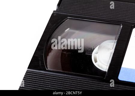 Vintage old black vhs cassette tape left reel closeup, side view, macro. 80s, 90s media, magnetic videotape film analog storage obsolete retro vhs Stock Photo