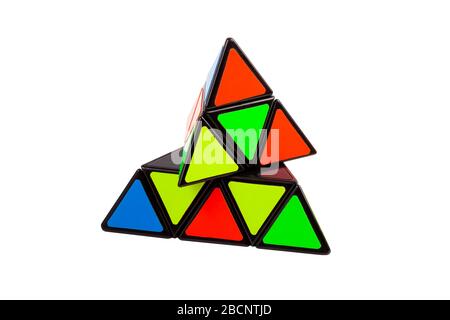 Simple abstract colorful pyramid triangular logical puzzle toy object isolated on white, displaced elements Creativity, intelligence, movement, change Stock Photo
