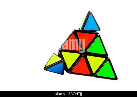 Triangular pyramid toy, complex logical puzzle with moving elements, parts isolated on white. Brain teaser, problem solving, intelligence, intellect Stock Photo