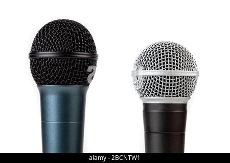 Pair of simple vocal microphones, mic grills closeup shot, objects isolated on white, cut out. Singing, recording voice studio equipment concept Stock Photo