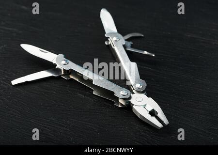 Multitool is a multi-functional tool on a black background. The concept of an expanded multi-tool with free space. Clipping path included isolate Stock Photo
