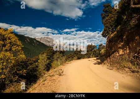 Dirt road on the road with no name between Batang and Ganbai Road, Sichuan Province shadowing the Tibetan border Stock Photo