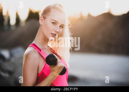 Pretty young woman doing sports Stock Photo