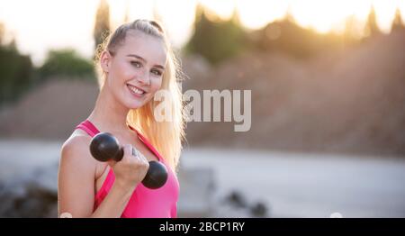 Pretty young woman doing sports Stock Photo