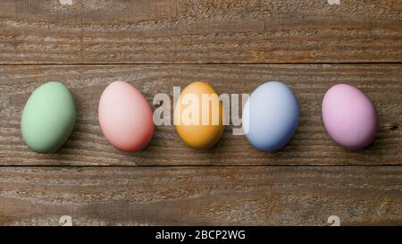 Five colored easter eggs on wooden boards Stock Photo
