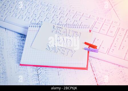 Text sign showing Health And Safety. Business photo text procedures intended to prevent accident in workplace notebook paper reminder clothespin pinne Stock Photo