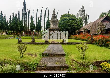 A stupa with statues of Buddha in Ulun Danu Beratan temple, Bali, Indonesia Stock Photo