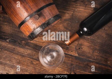 Oak Barrel and wine bottle over a wooden table Stock Photo