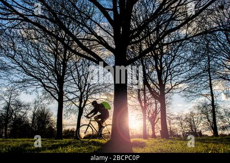 A cyclist keeps fit under lock down for Coronavirus Covid 19 restrictions in March 2020 Stock Photo