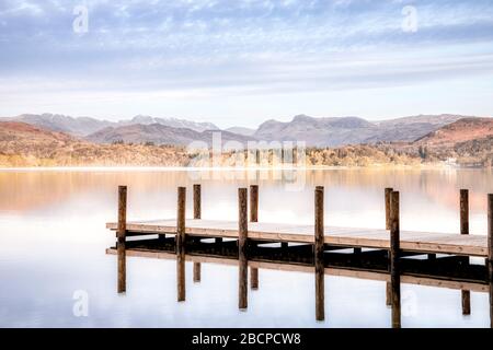 Misty early morning at Lake Windermere looking towards the Langdale Pikes Stock Photo