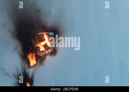 Apartment fire is caused by electrical outlet faults. Burnt and damaged electric plug socket from overload short circuit. Stock Photo