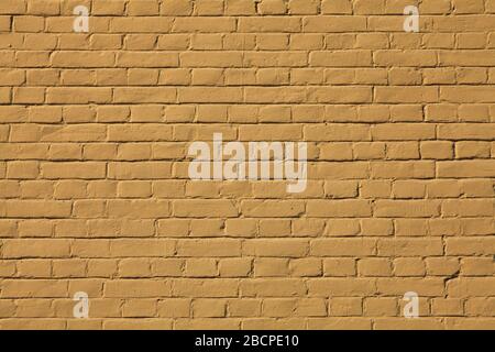 Brick wall texture, background in camelopard color (light-brown). The building wall, painted with cooper water-based paint. Umber, ochre and brownish Stock Photo