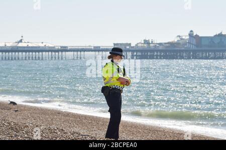 Brighton, UK. 5th Apr, 2020. Police and PCSOs patrol Brighton beach on a sunny day after the government had told the public to stay at home this weekend despite the forecast of warm sunny weather during the Coronavirus COVID-19 pandemic crisis . Credit: Simon Dack/Alamy Live News Stock Photo