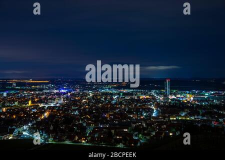 Germany, Magical night atmosphere over fellbach city skyline, aerial view above the houses by night Stock Photo