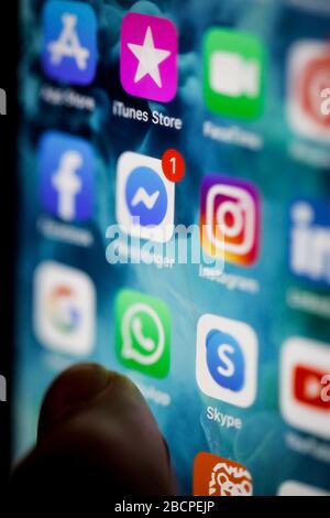 Bucharest, Romania - April 5, 2020: Macro image with various apps (Instagram, Facebook messenger, Whatsapp, Skype, iTunes Store) on a mobile device. Stock Photo