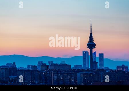 View of the skyline of Madrid, with the mountains in the background, in a beautiful sunset. Spain. City and travel concept. Stock Photo