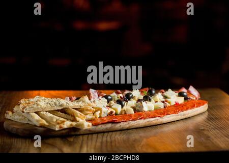 Prosciutto, spicy italian sausage and cheese with nuts and candidated fruits on the plate Stock Photo