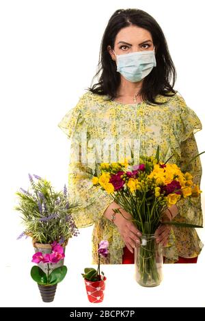 Floswer shop woman worker during coronavirus wearing protective mask isolated on white background Stock Photo