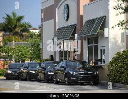 COCONUT CREEK, FL - APRIL 04: Customers are seen lining up at the Starbucks drive-thru as a stay-at-home order has been issued by Florida Governor Ron DeSantis due to the Coronavirus (COVID-19) pandemic on April 4, 2020 in Coconut Creek, Florida. Credit: mpi04/MediaPunch Stock Photo