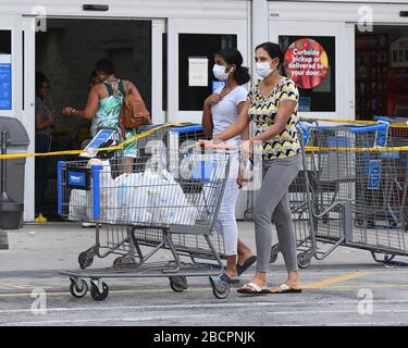 COCONUT CREEK, FL - APRIL 04: Shoppers stock up as Walmart on Saturday began limiting the number of customers who can be in it's stores at once due to the Coronavirus (COVID-19) pandemic on April 4, 2020 in Coconut Creek, Florida Credit: mpi04/MediaPunch Stock Photo