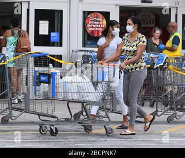 COCONUT CREEK, FL - APRIL 04: Shoppers stock up as Walmart on Saturday began limiting the number of customers who can be in it's stores at once due to the Coronavirus (COVID-19) pandemic on April 4, 2020 in Coconut Creek, Florida Credit: mpi04/MediaPunch Stock Photo