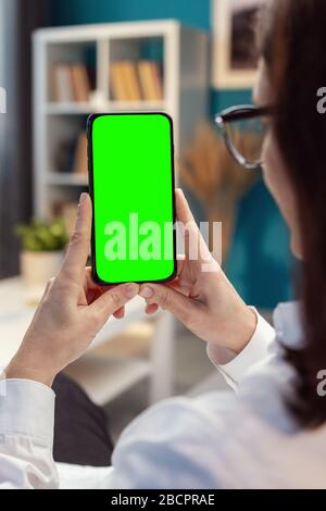 Woman hands vertically holding cellphone Stock Photo