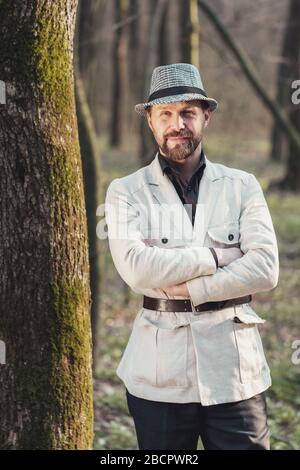 Smiling man standing in parkland Stock Photo