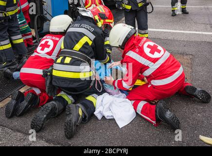 Emergency service personnel free an injured driver at the scene of a traffic accident during a training exercise.  firefighters, paramedics and Italia Stock Photo