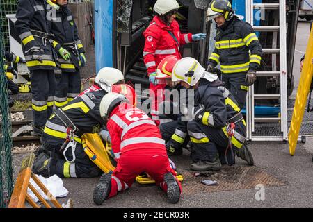 Emergency service personnel free an injured driver at the scene of a traffic accident during a training exercise.  firefighters, paramedics and Italia Stock Photo