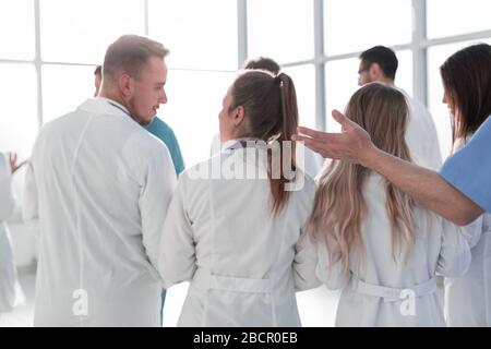group of doctors discussing something standing in the hospital lobby Stock Photo