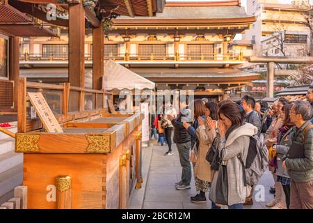 tokyo, japan - march 02 2020: Japanese queuing and praying in the Yushima shrine of Tokyo dedicated to the god of studies Sugawara no Michizane. Stock Photo