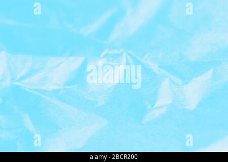 Crumpled blue turquoise with light shadows paper texture abstract background Stock Photo