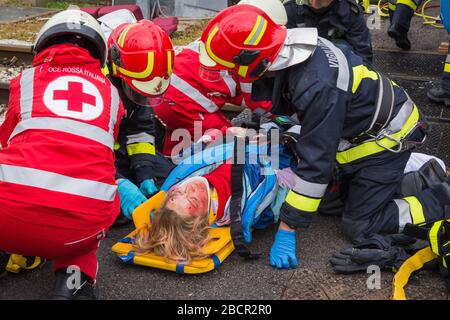 Emergency service personnel free an injured driver at the scene of a traffic accident during a training exercise.  firefighters, paramedics and Italia Stock Photo