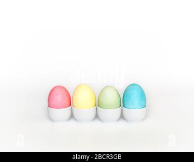 Colorful Easter eggs in stands on a white background. Easter concept. Copy space. Stock Photo