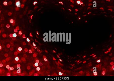 valentines day red abstract background with heart glitter bokeh on black, valentines day card, abstract love bokeh shiny confetti textured template Stock Photo