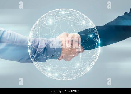 Two Unrecognizable Businessmen Handshaking Over Holographic Earth Globe, Double Exposure Stock Photo