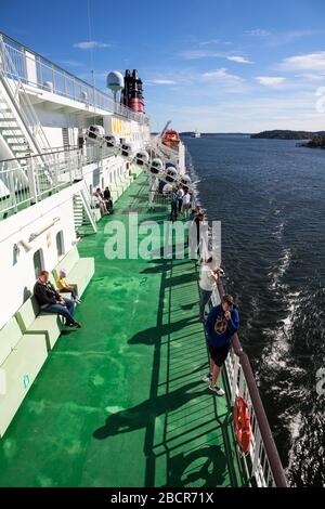 BALTIC SEA, SWEDEN - CIRCA JUN, 2018: People are on upper side deck of cruise ferry boat. It is cruise liner of Viking line Finnish shipping company. Stock Photo