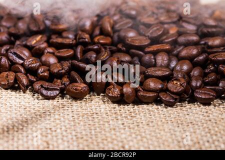 coffee beans on burlap background Stock Photo