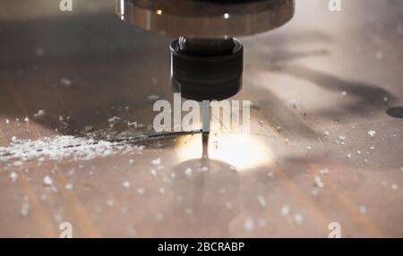 End mill processes the plastic sheet on a CNC milling machine, close-up photo with selective focus Stock Photo